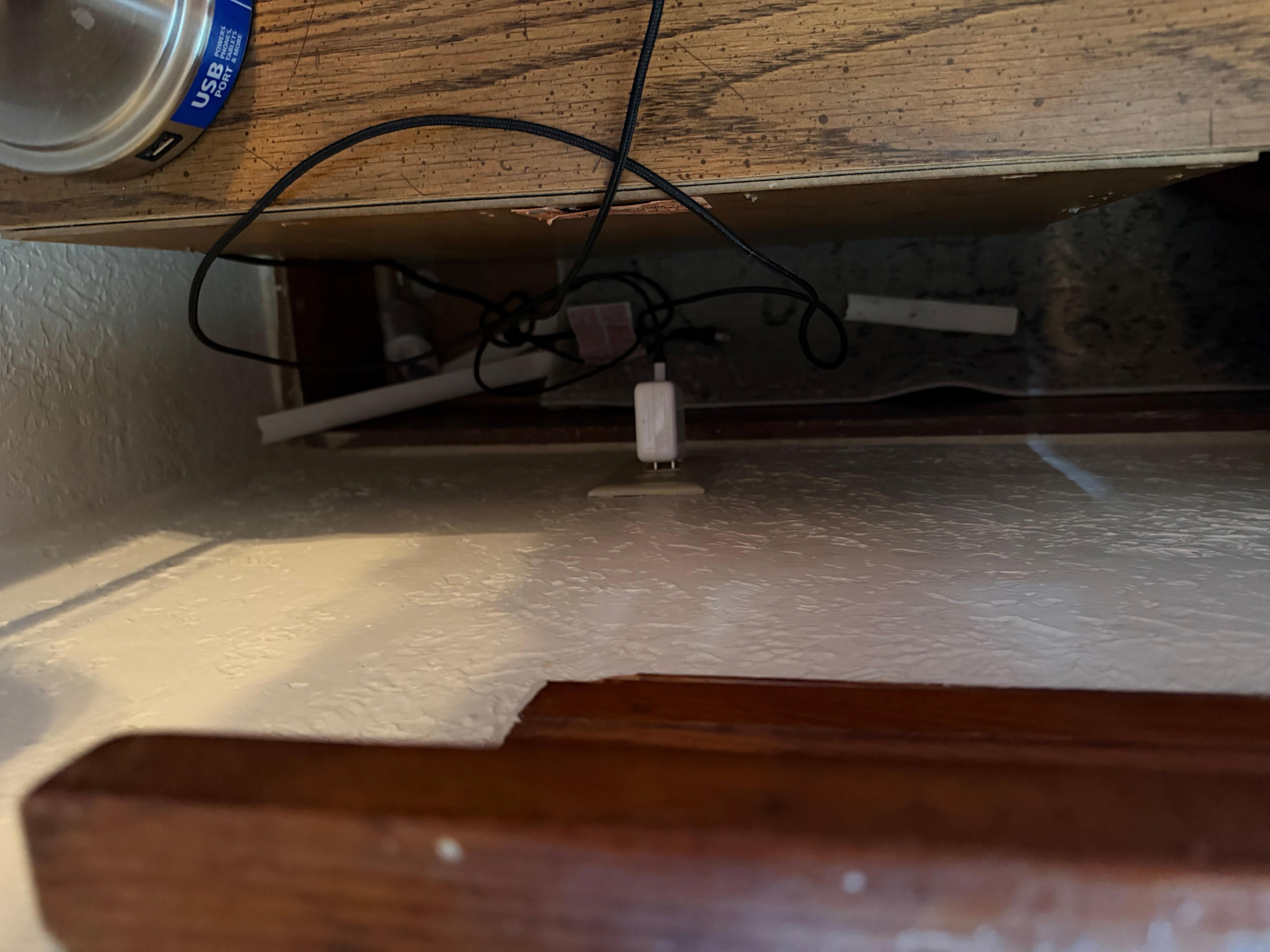 Behind end table in Master