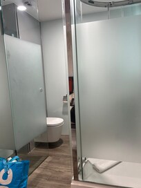 How close the shower room was to the end of the bed