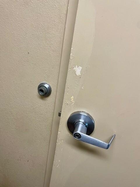 Bathroom door worn, in general disrepair