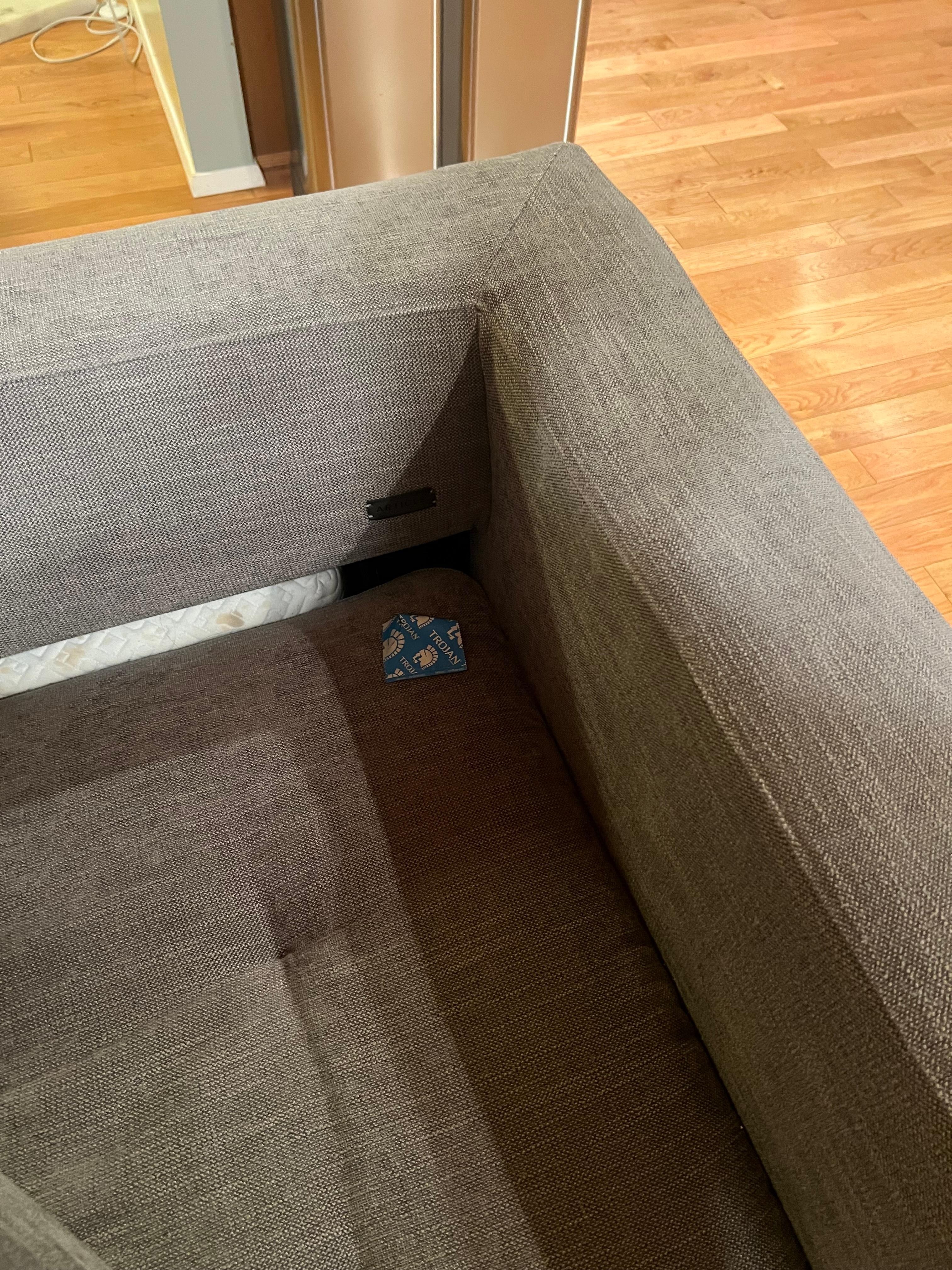 Used condom wrapper left on the couch