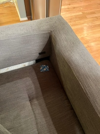 Used condom wrapper left on the couch