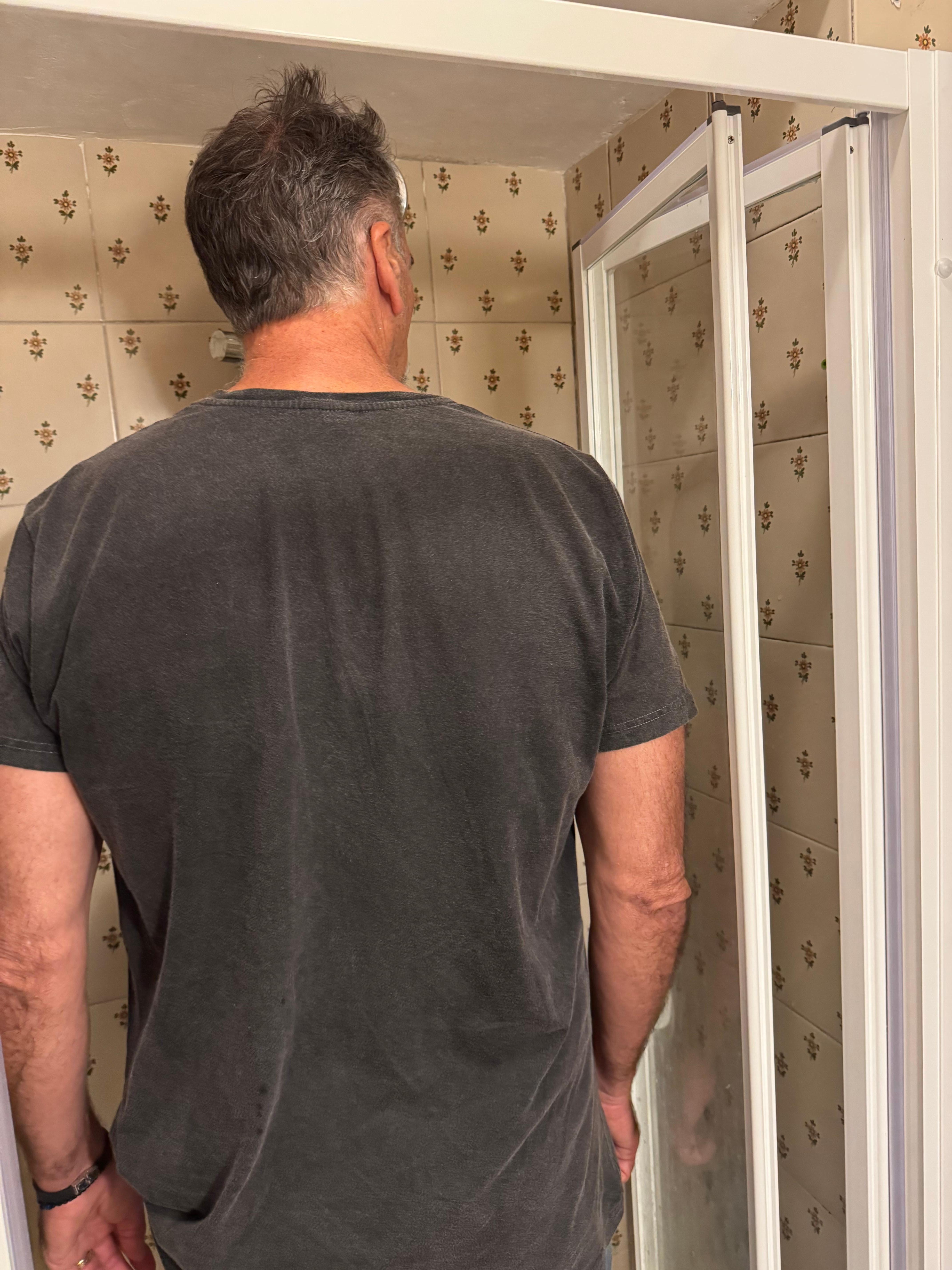 Shower - he is tall (6'4") but I am small and even had a hard time.  Don't drop anything!