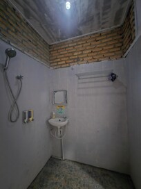 The bathroom with tbe lights on during the day