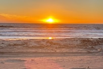 Sunset steps from the house on the beach