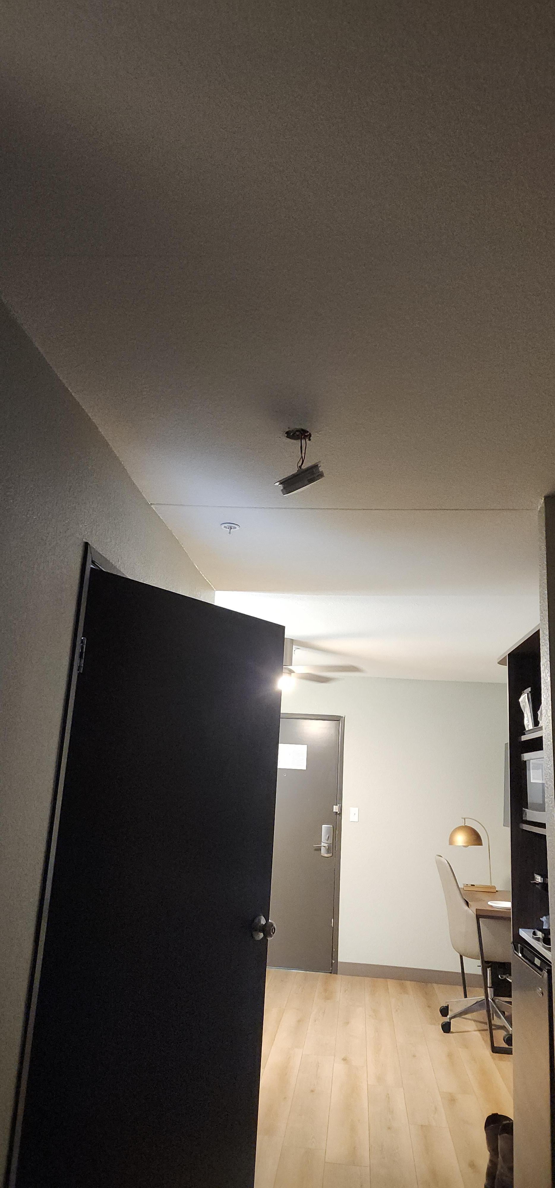 Fire alarm dangling by it's wires and kickboard falling off the walls