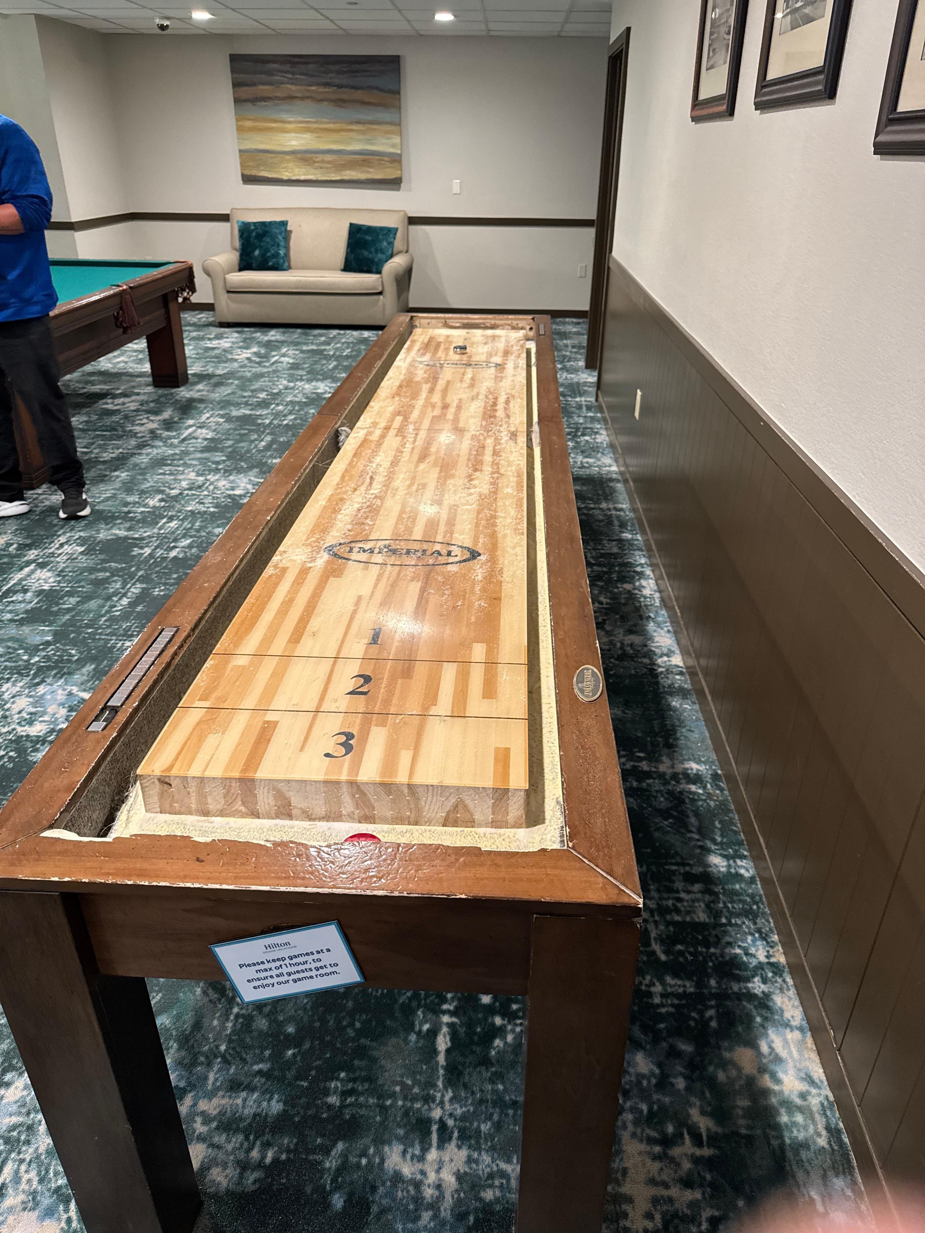 Shuffle board table is broken and slanted