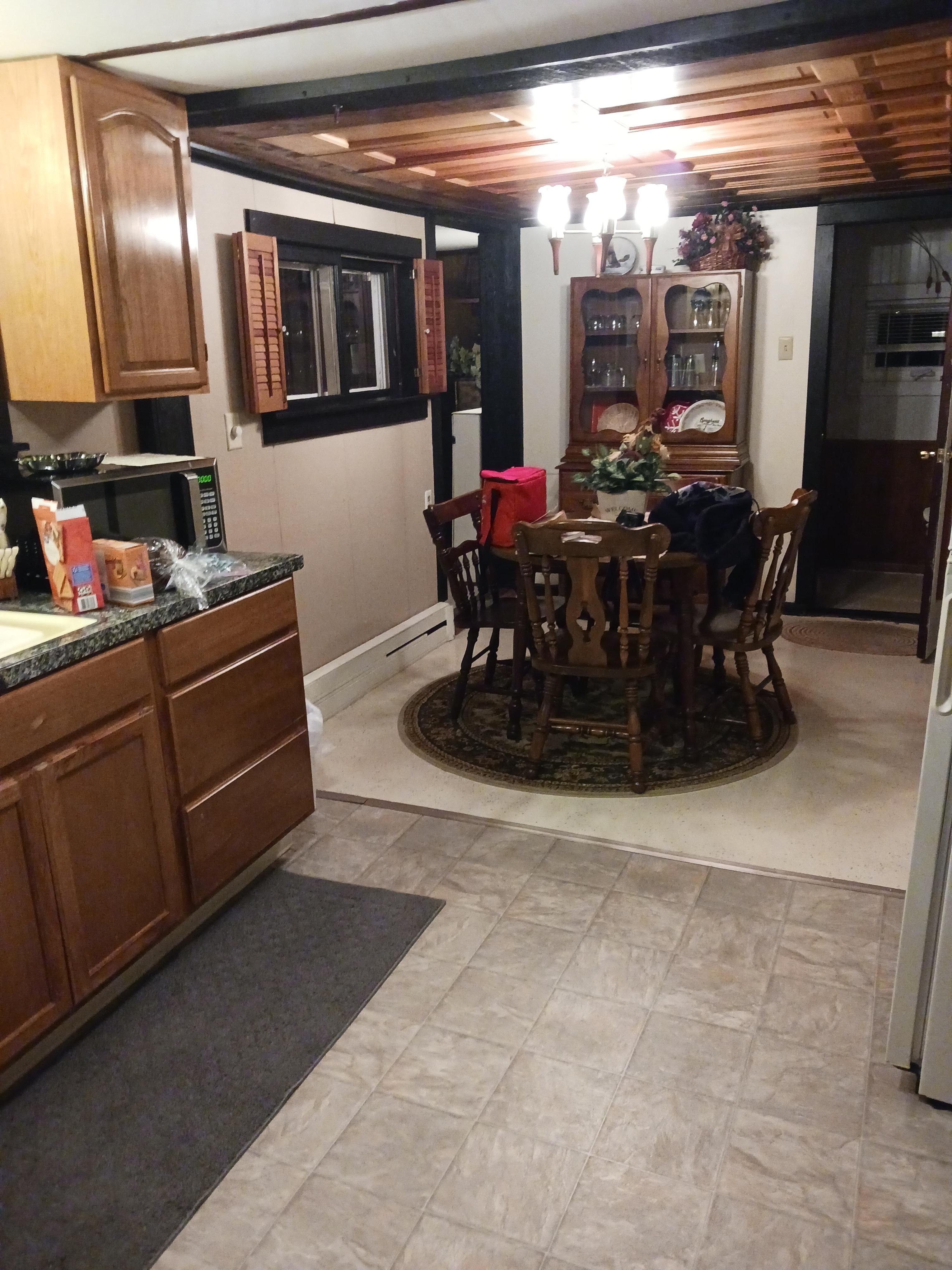Kitchen and dining area. Kitchen has stove, rfridge, microwave, coffee maker, pots, pans, dishes, utensils. 