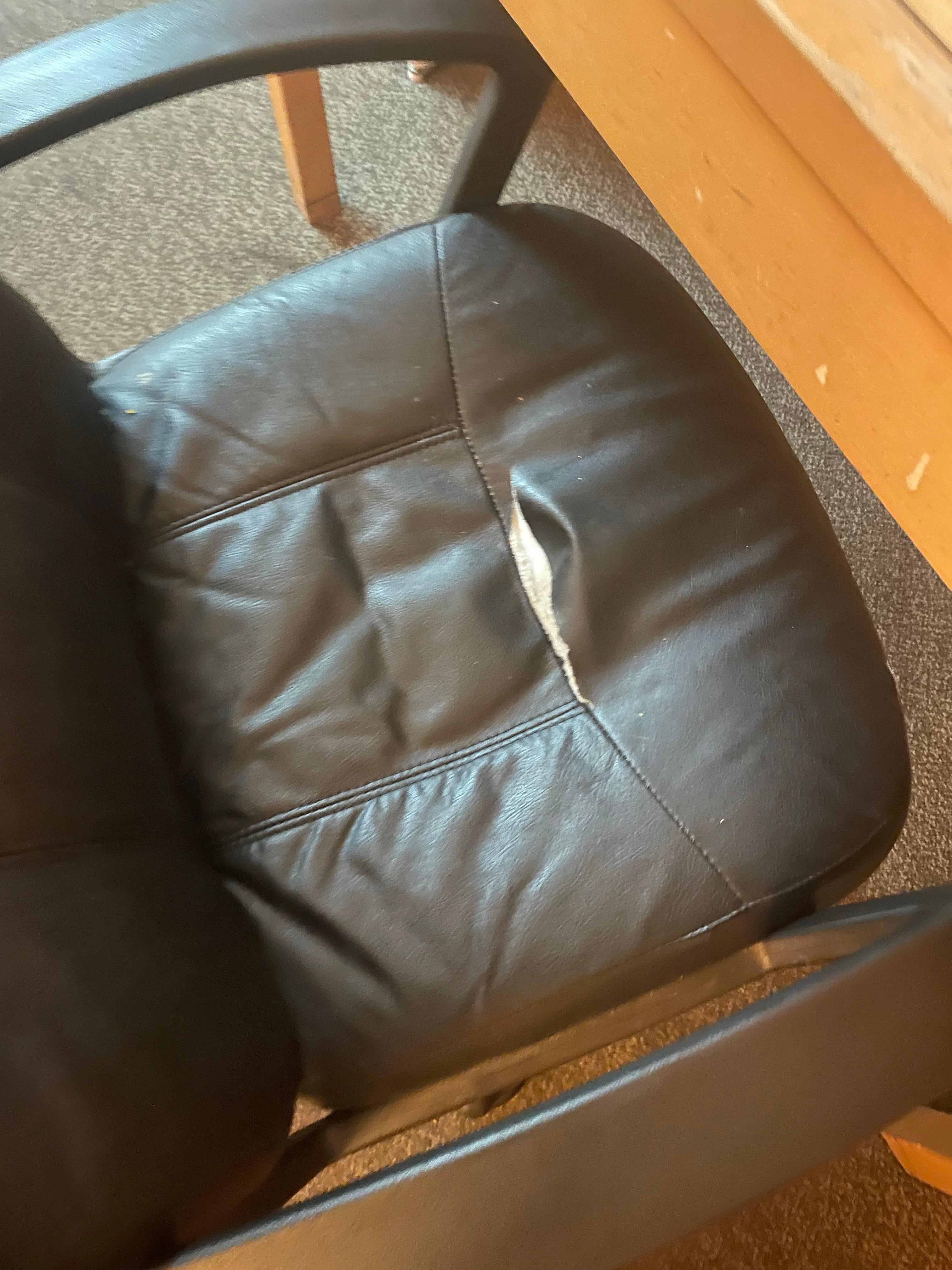 the seat of the office chair is torn.