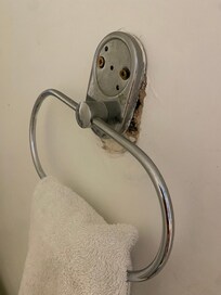 Towel holder held in by one screw
