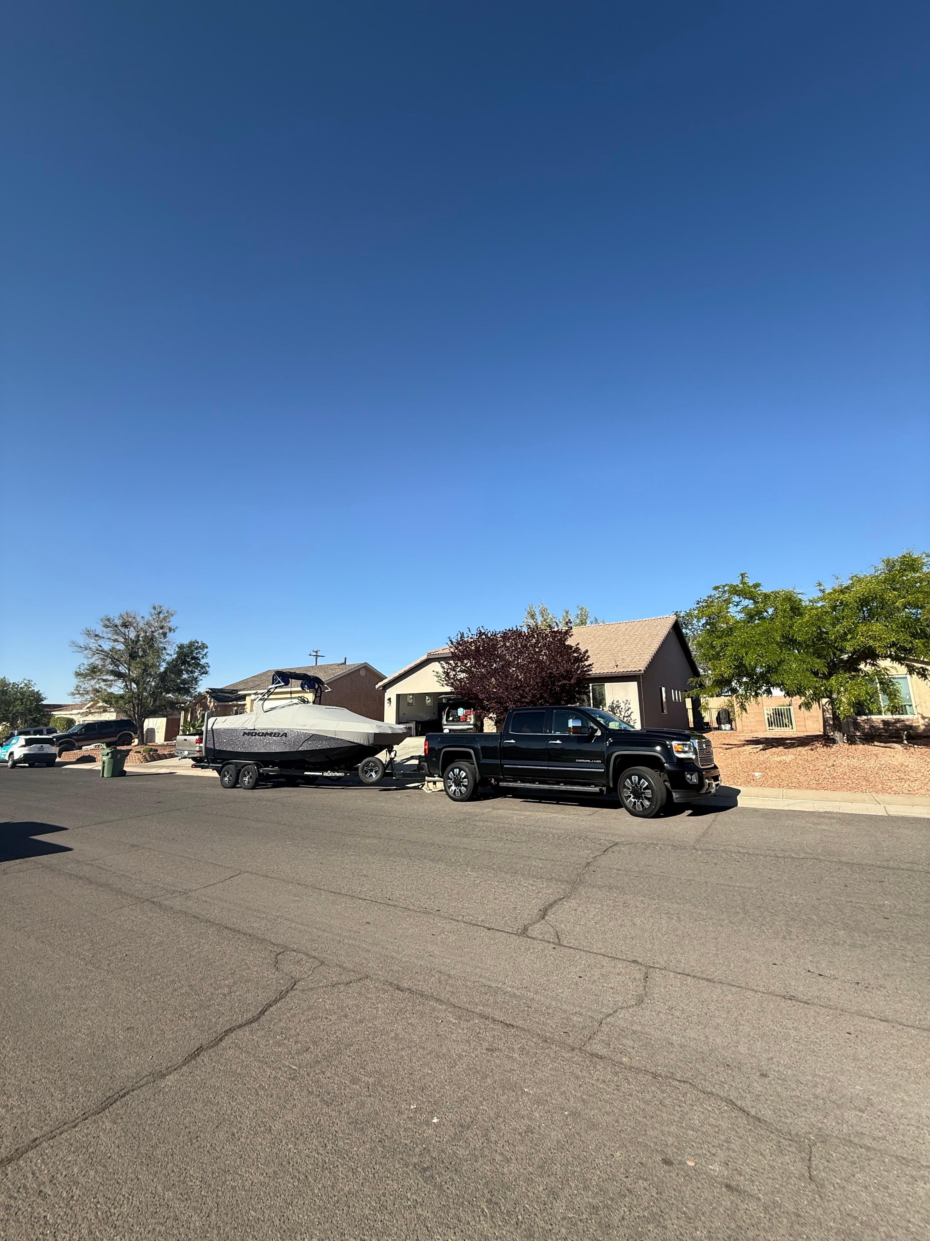 Boat and truck barely fit. The neighbor left this day so there was more space in the street. 