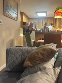 From one of large family rooms looking into kitchen. Fixing dinner