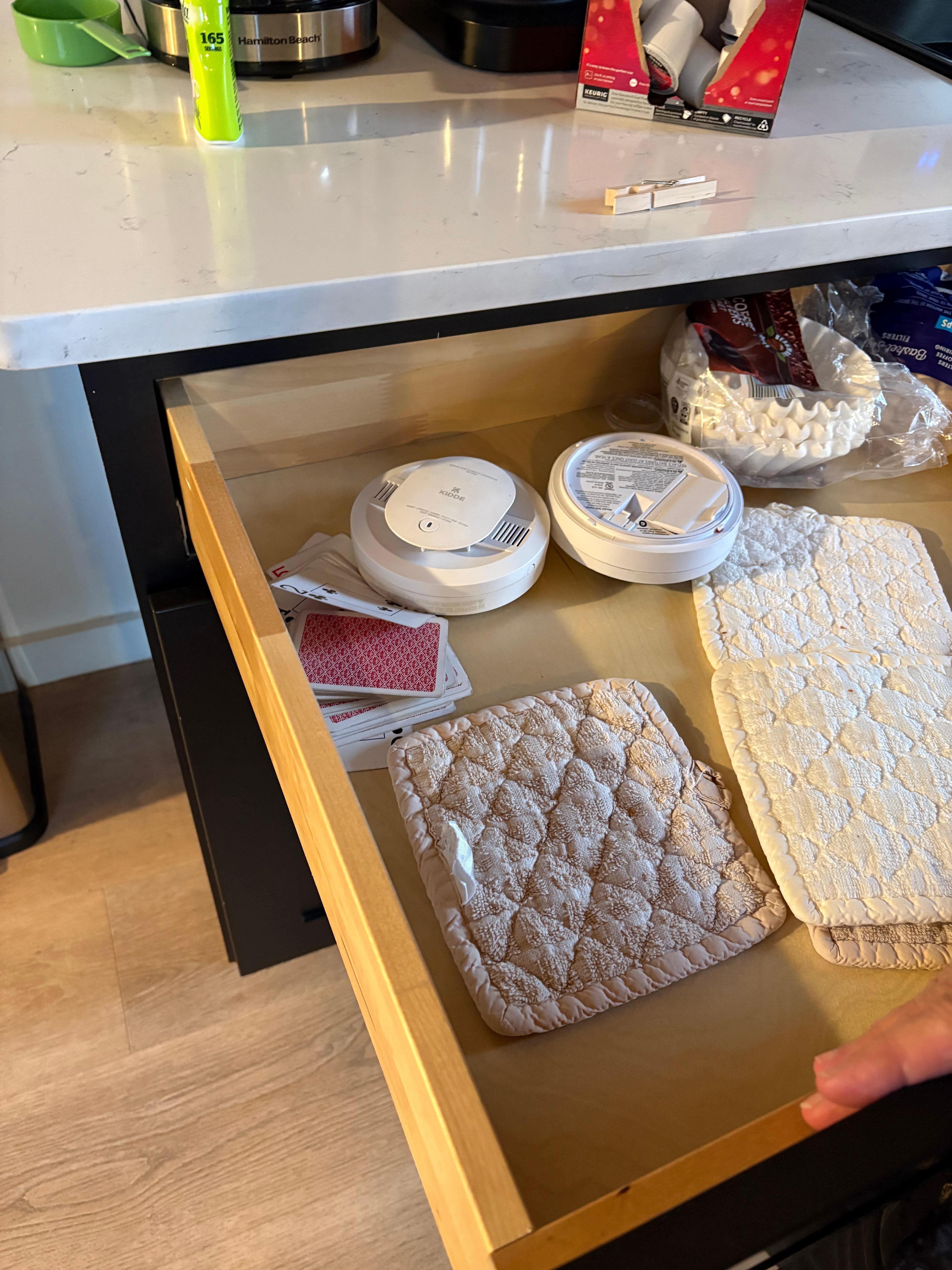 Located smoke detector in kitchen drawer.