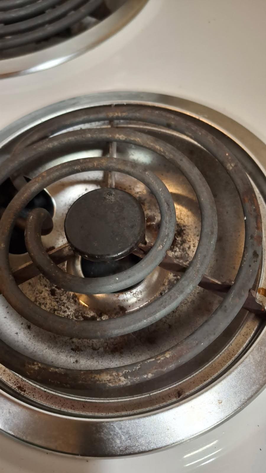 Grease and grim under the burners on the stove 