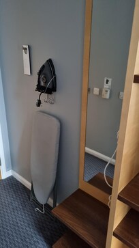 Mirror, iron and ironing board hairdryer at side.