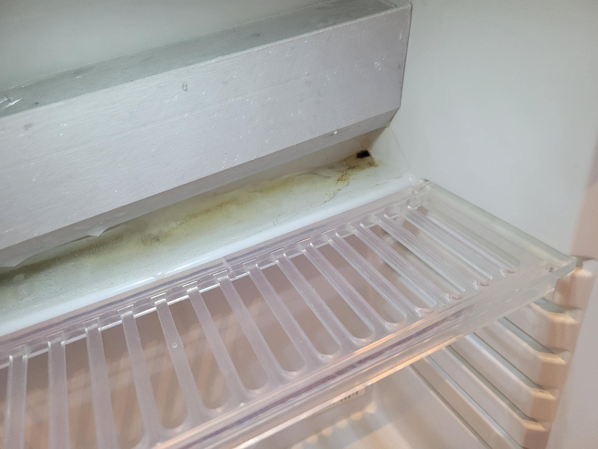 Leerer extrem dreckiger Kühlschrank.