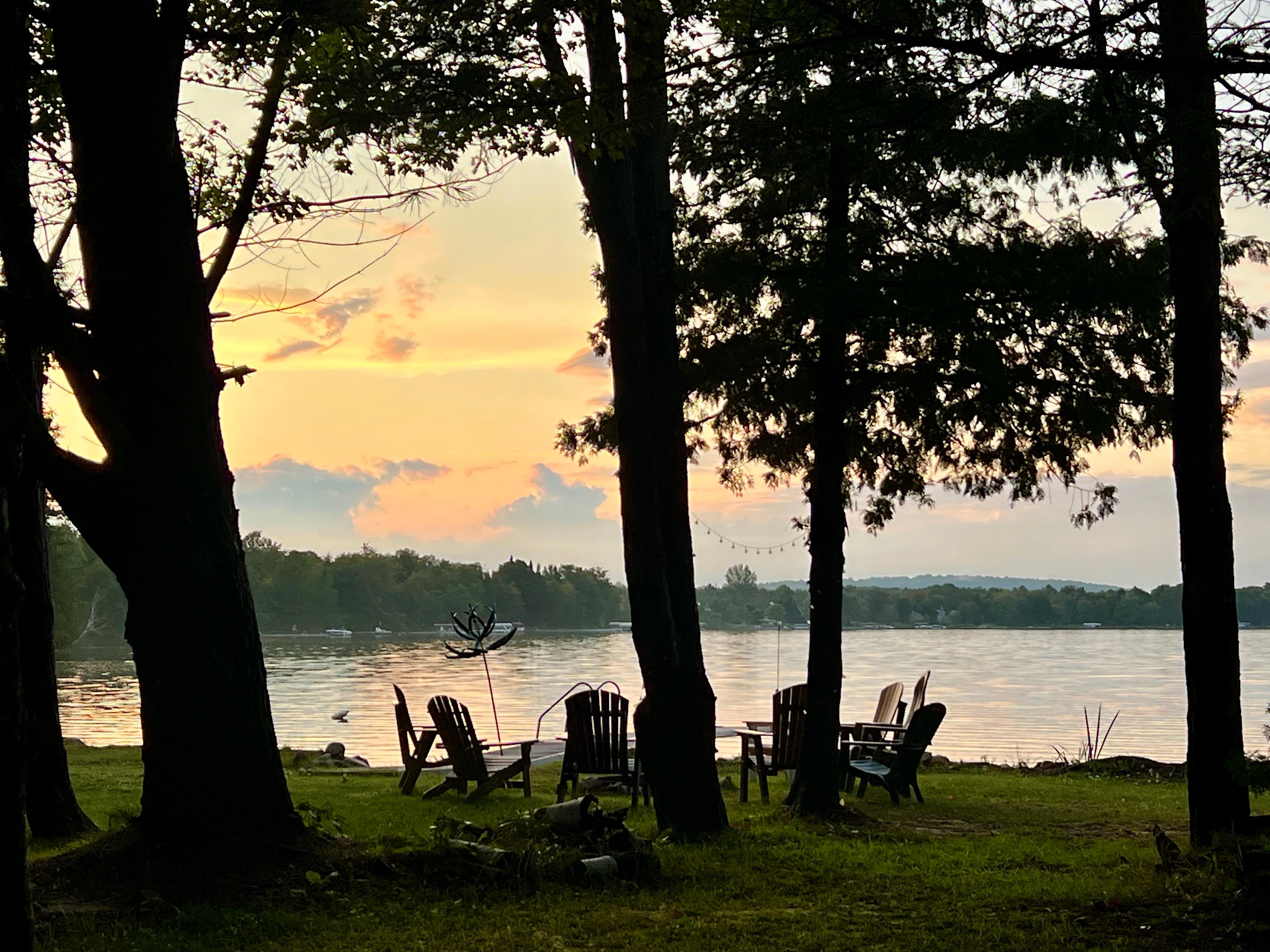 Fire pit with chairs by the lake