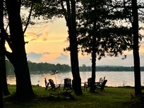 Fire pit with chairs by the lake