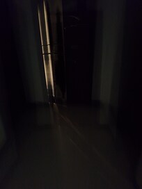 Hallway with no lights. This is hall outside our door.