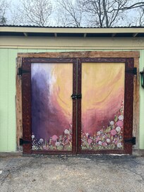 The painted door on the workshop next to the cabin.