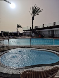 Ample swimming pool and sun loungers