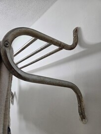 Towel rack covered in rust.