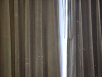 The blackout curtains had holes in them. The room was dingy