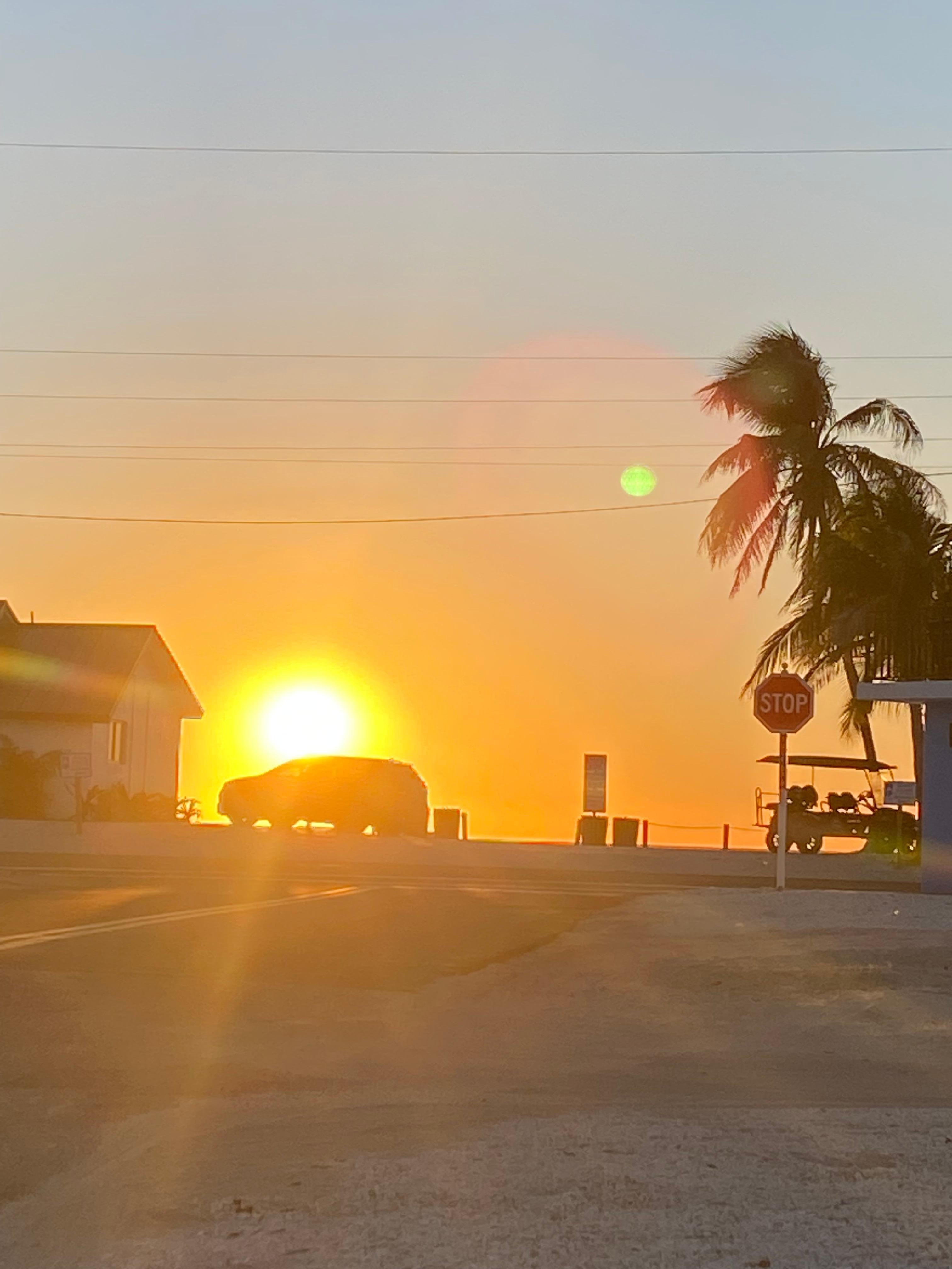 Picture taken of sunset over beach from the parking lot of our place. 
