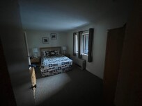 Bedroom in “suite” is dark and located under wood stairwell - hope you’re a sound sleeper