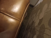 Dirty rug behind dirty sofa