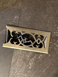 Photo of broken floor grate, unsafe for bare feet/children