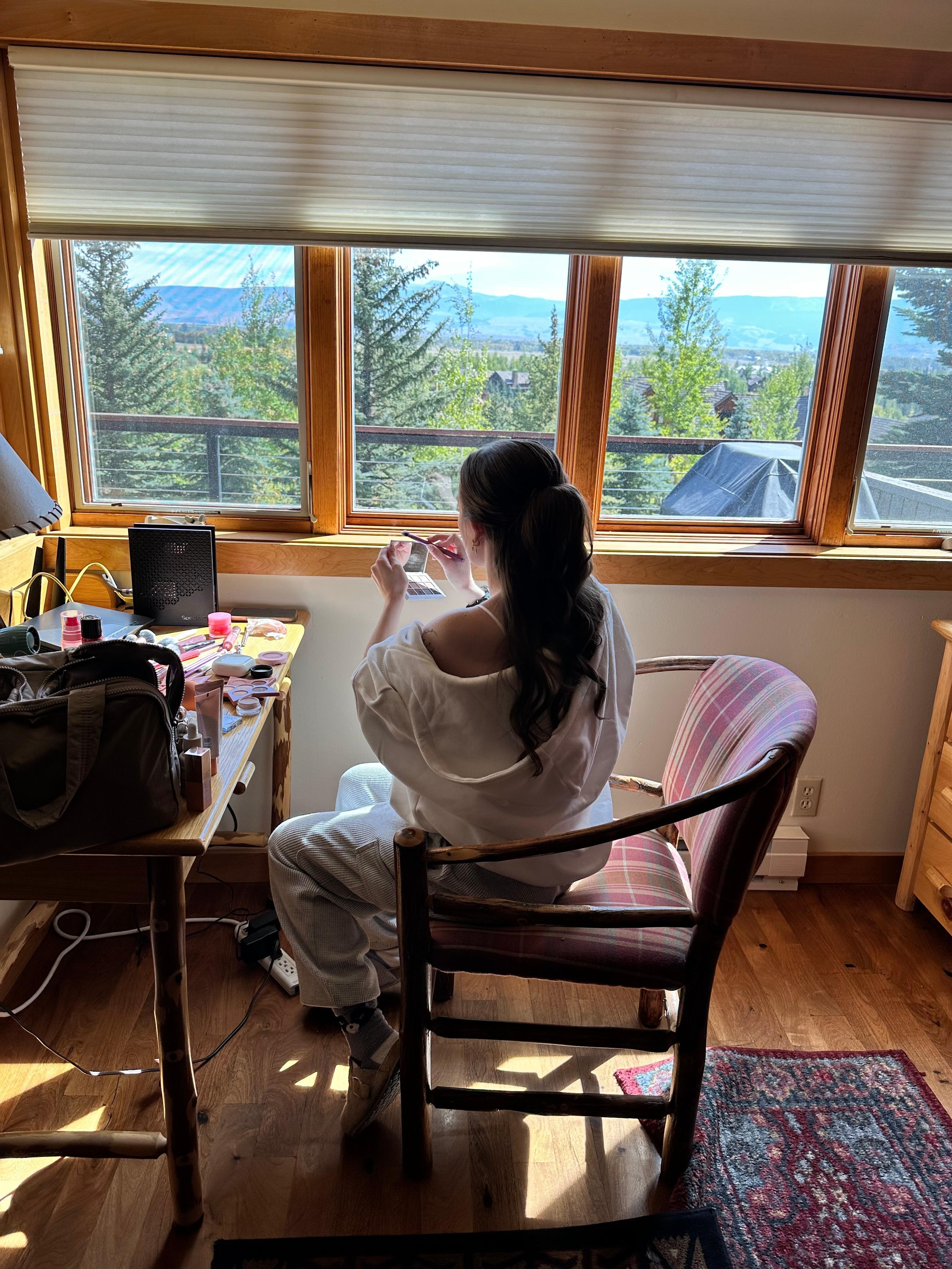 My daughter putting her makeup on the day of her wedding