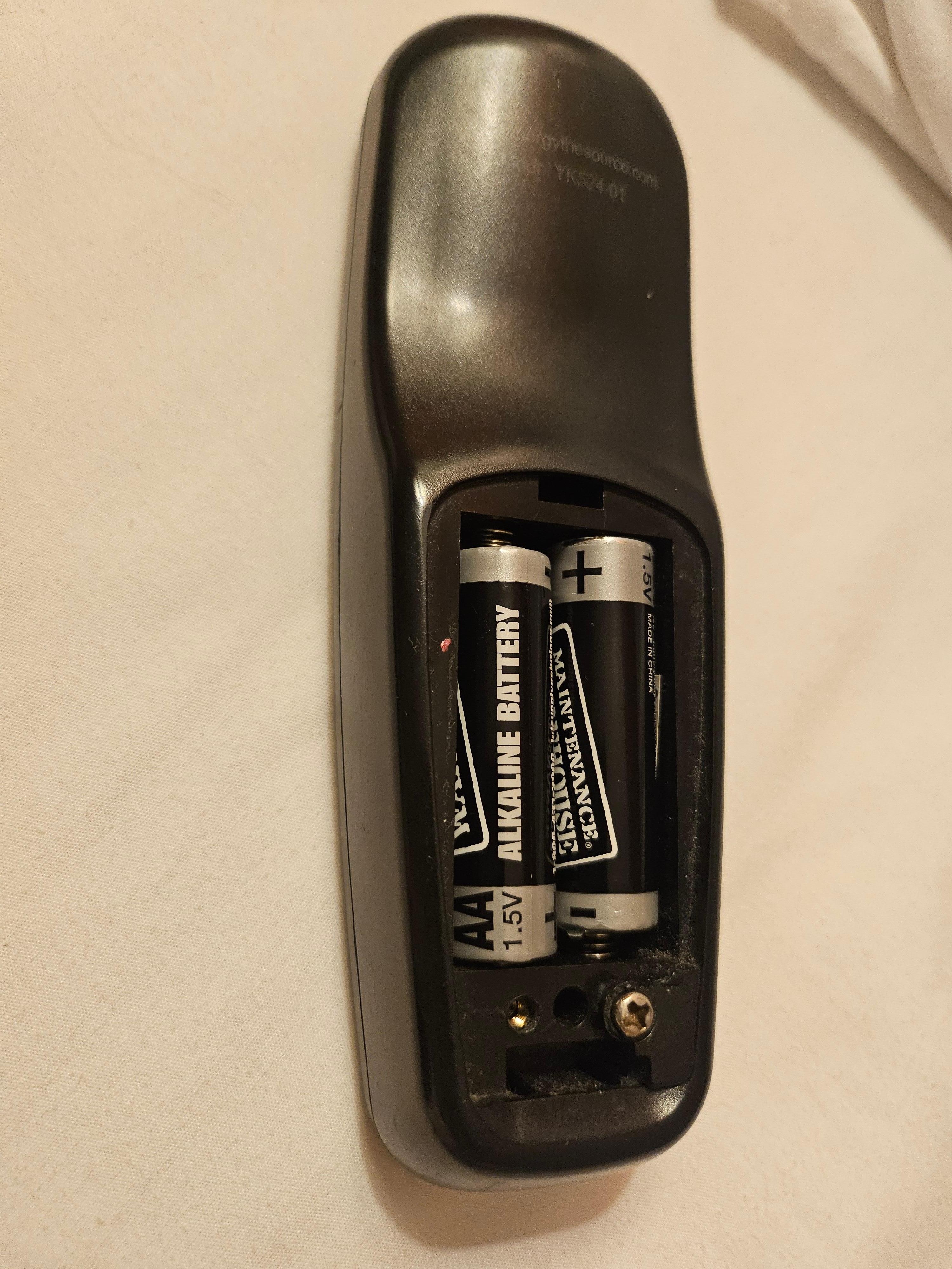 TV remote control's battery cover is missing.