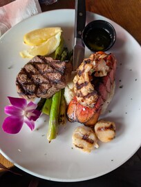Check out Walt's Fish Market. Great food and not overly priced on the surf and turf.