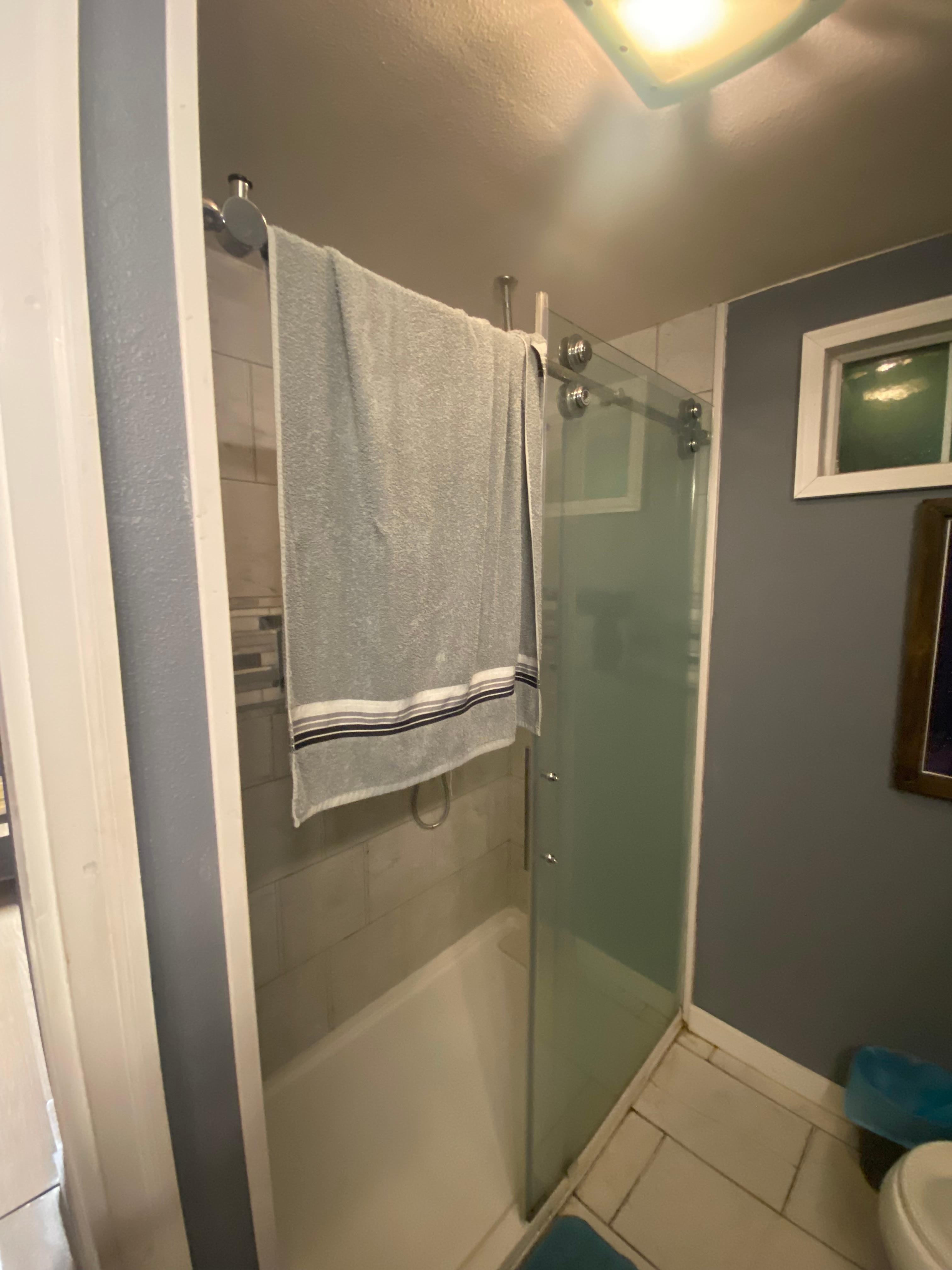 Dirty towel hanging over shower door