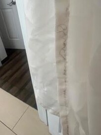 Shower curtain encased in hair and grime