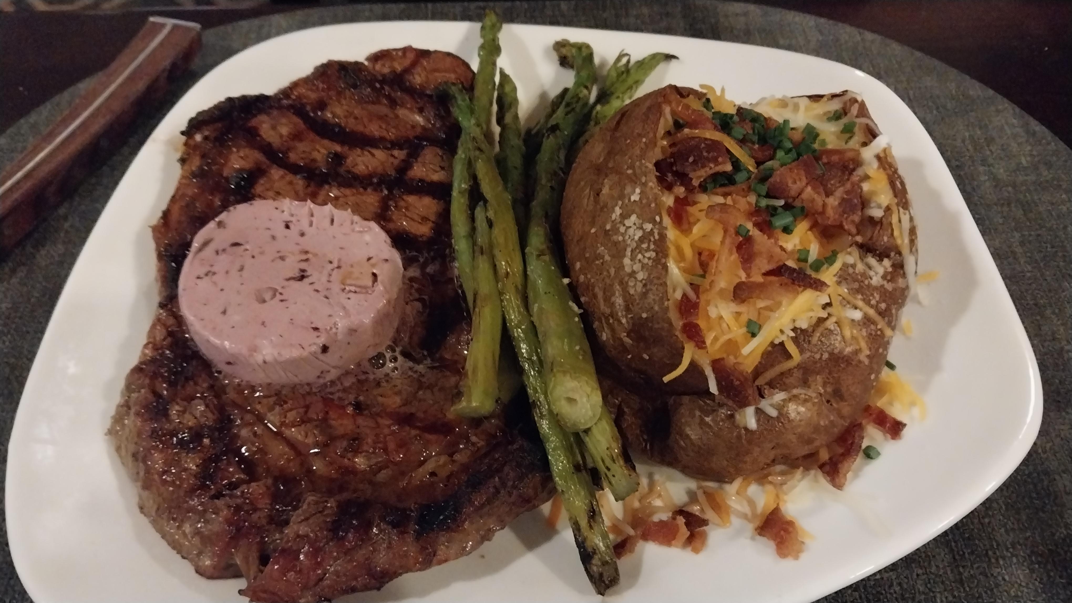 14oz ribeye cooked medium rare with rosemary garlic butter.