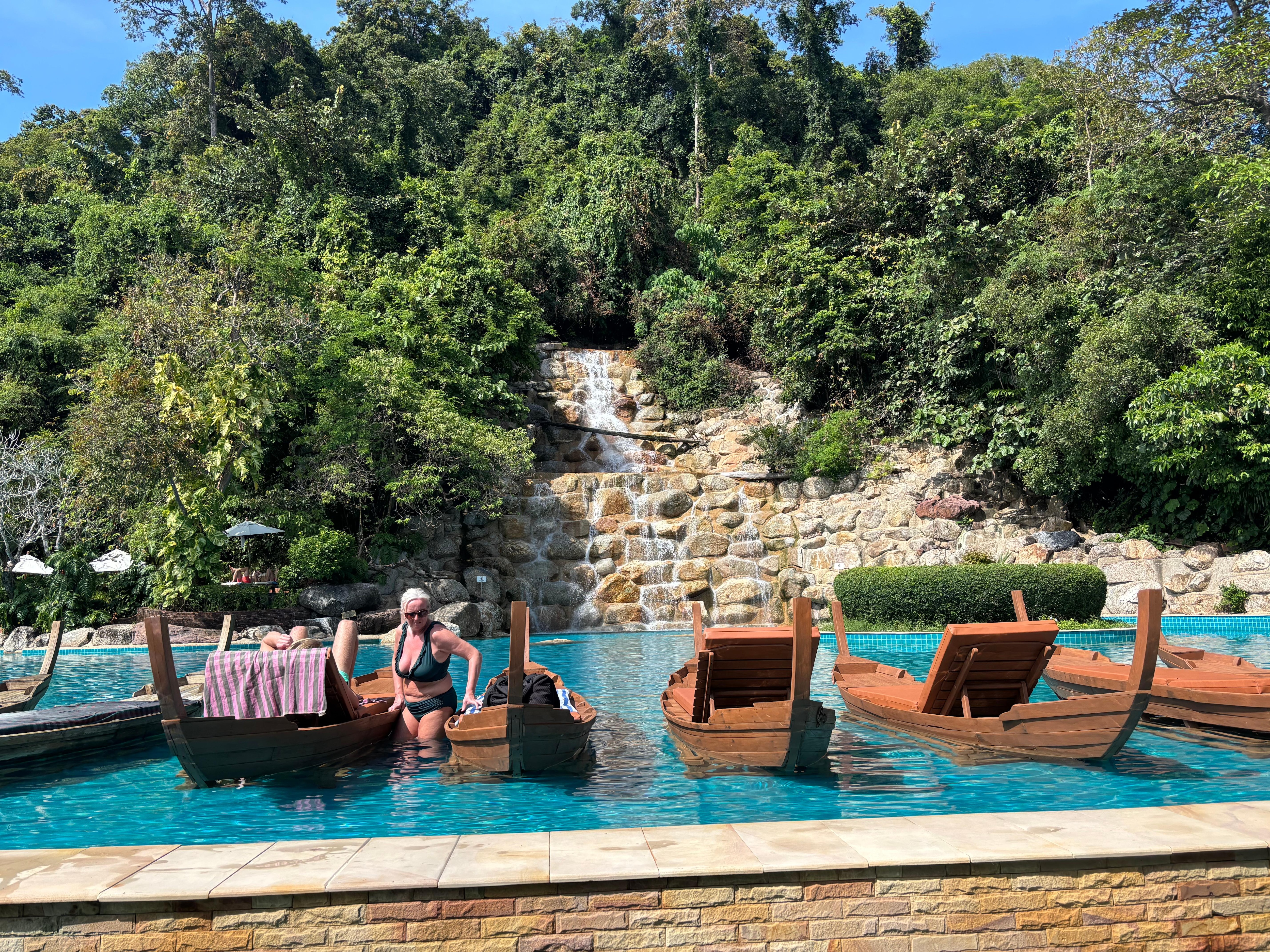 Pool by beach with waterfall