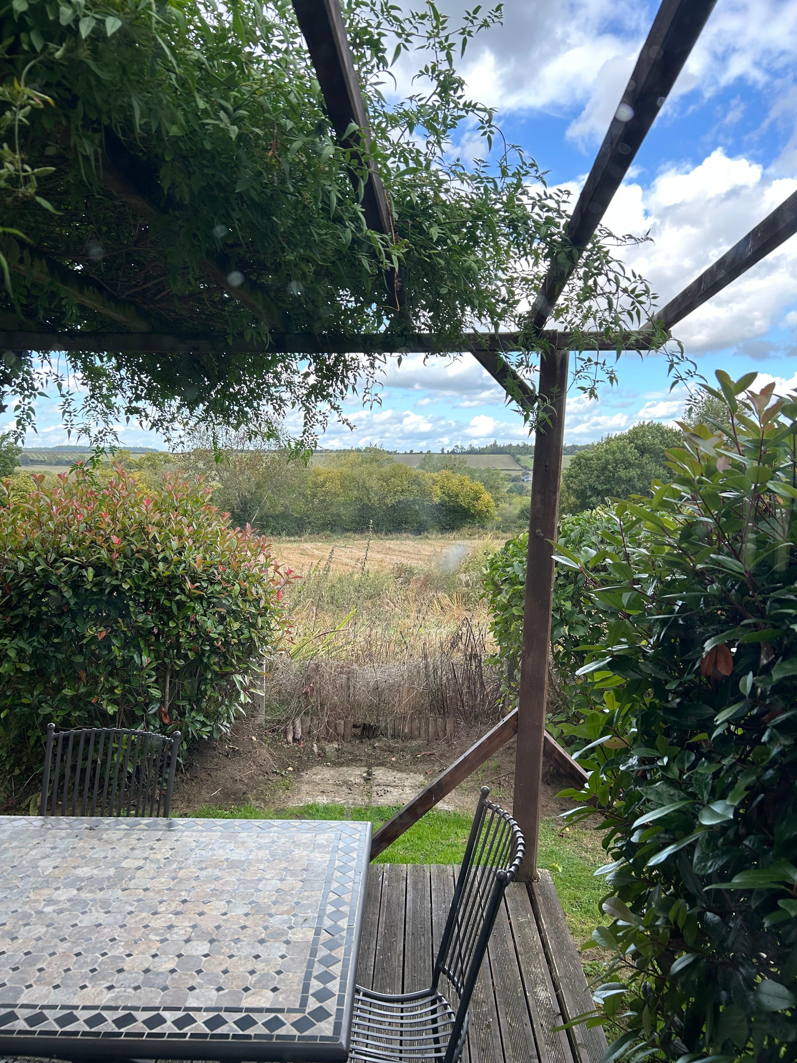 View at back of house at outdoor siting/eating area