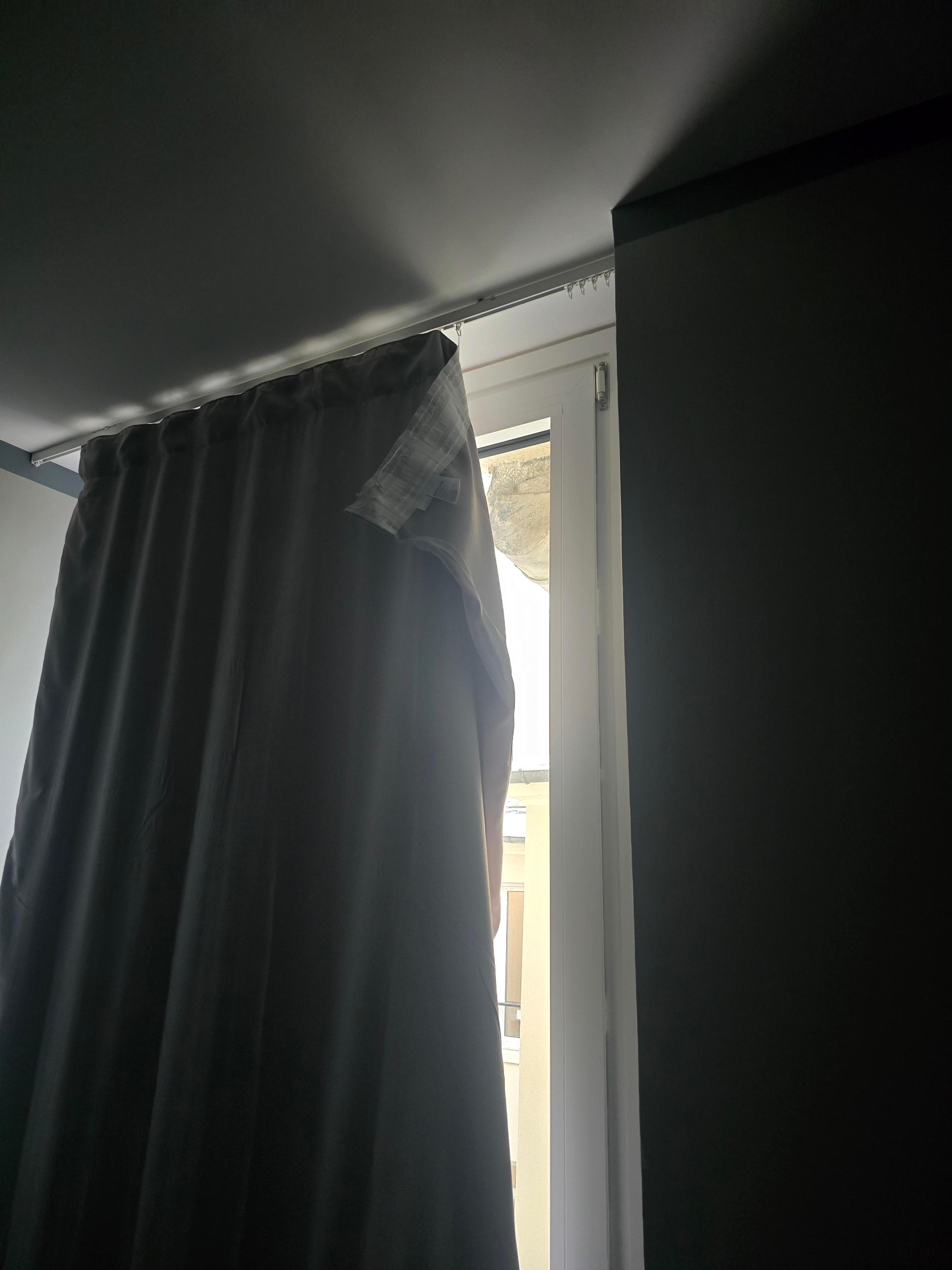 Cheap curtains, barely hung.