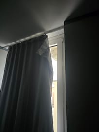 Cheap curtains, barely hung.