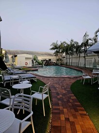 Pool area including lounges (some covered for sun protection) and QR codes for food/drink service.