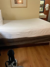 Bed with fresh sheets but no blankets