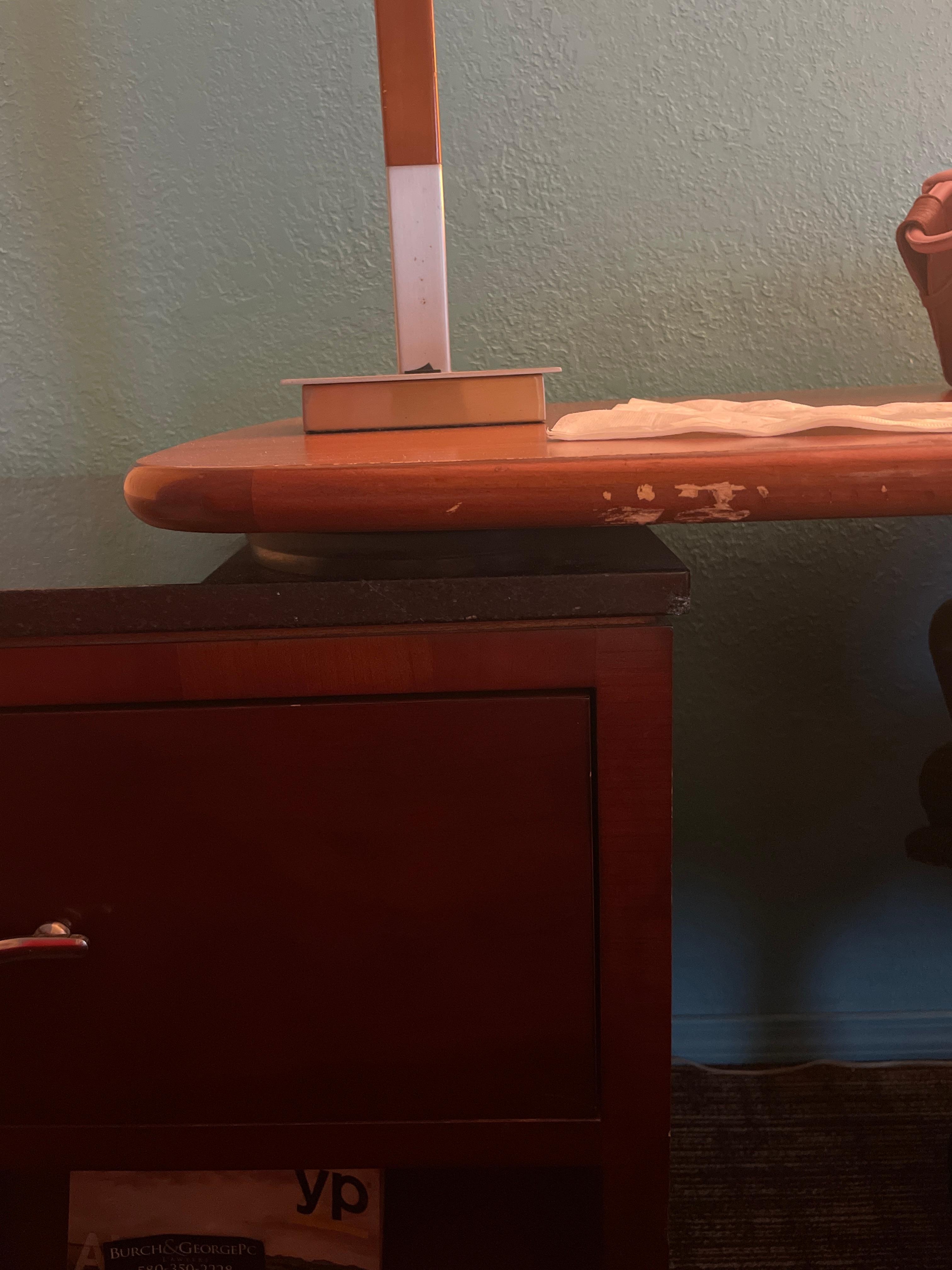 Desk by red chair by door