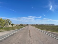 View from camp entrance with Badlands at the end of this road.
