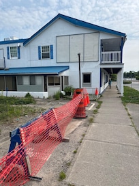 Building boarded up and yard fenced off