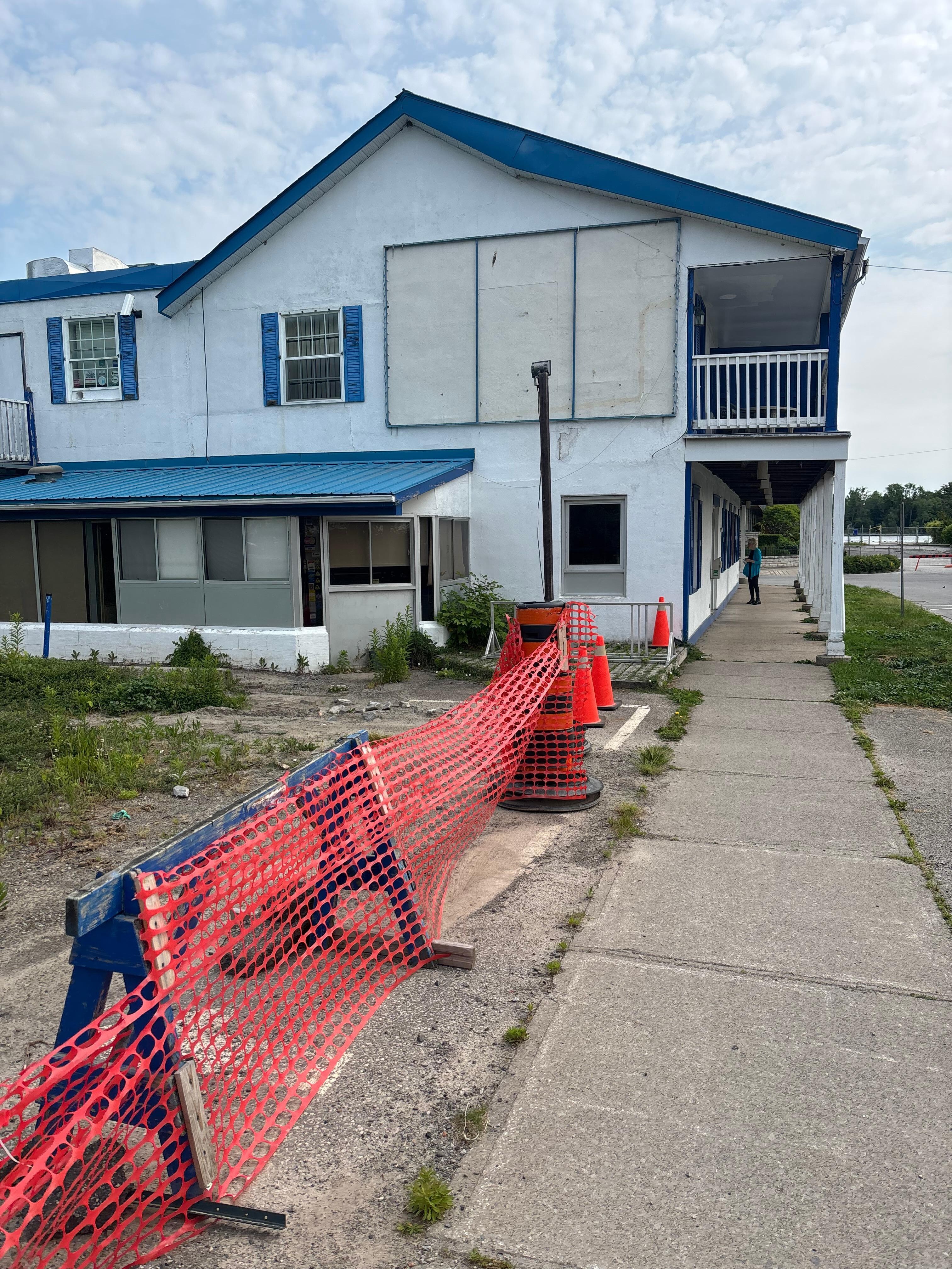 Building boarded up and yard fenced off