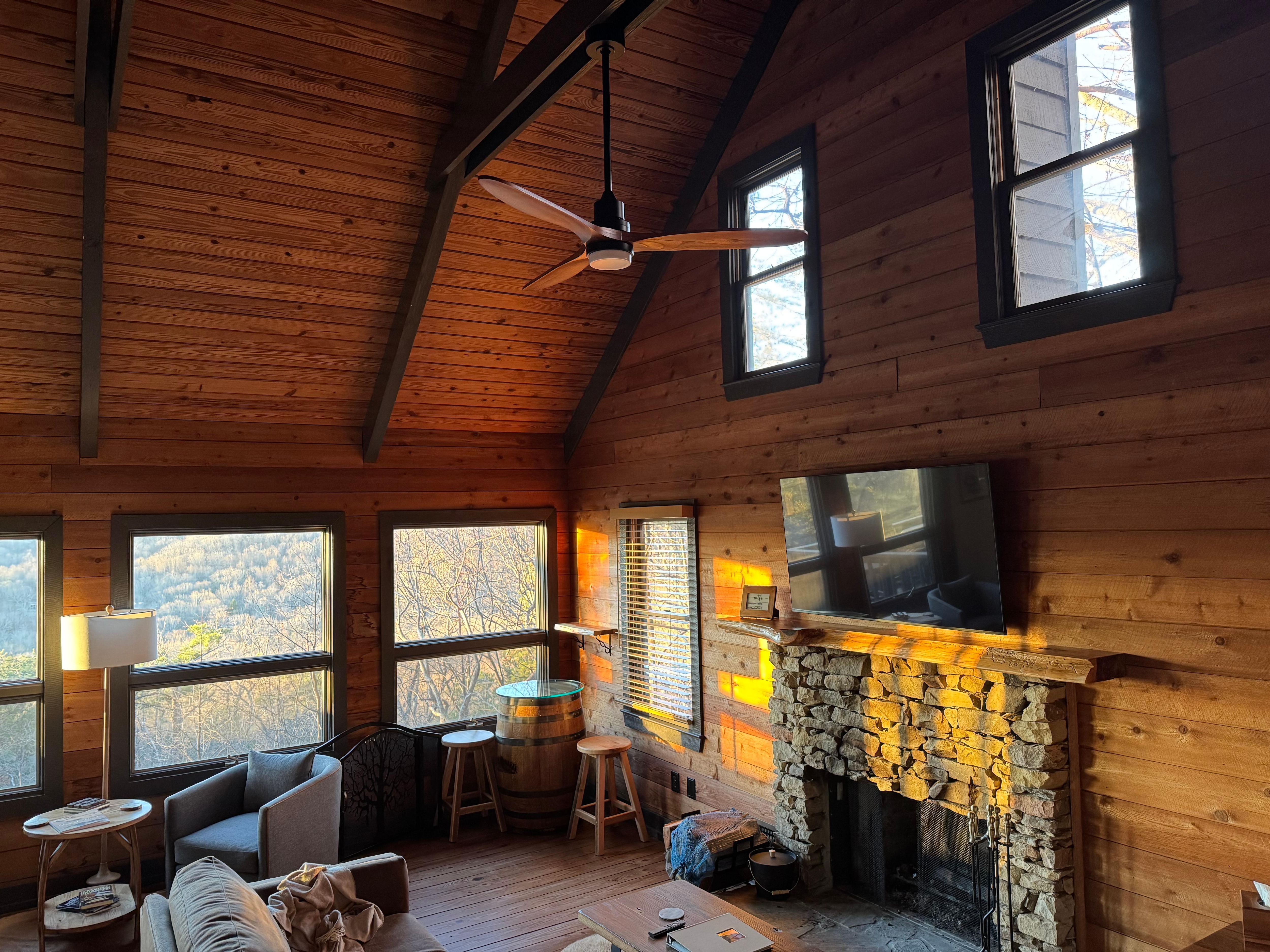 The sunrise casts great light into the house through all the glass. 