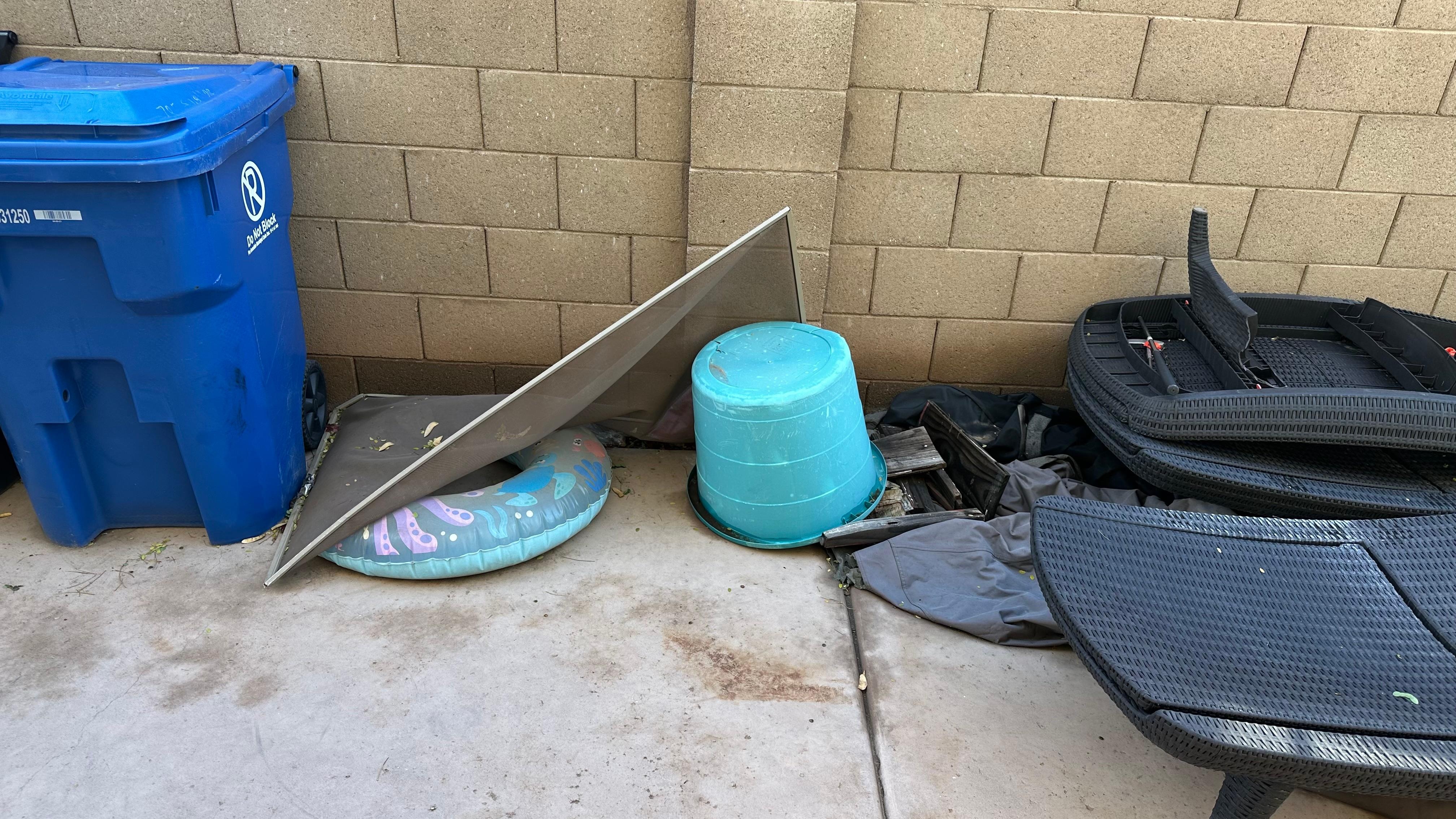 Trash along the side of the house