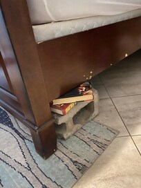 Cinder block and old books supporting bed