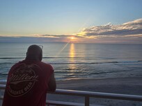 My husband watching the sunrise.